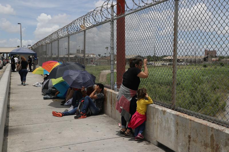 A Honduran mother and her 3-year-old daughter wait with fellow asylum seekers on the Mexican side of the Brownsville-Matamoros International Bridge after being denied entry by U.S. Customs and Border Protection officers near Brownsville, Texas, U.S., June 24, 2018.